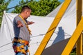 Zipline. A person checks the equipment before zipling. Starting platform on a high rock. Extreme and active rest.