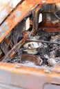 Ukraine, Motyzhyn - Yasnohorodka - 04.25.2022: Broken and burned civilian car. Close photo, element. Burnt dishes in a destroyed c