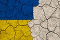 Ukraine national flags grunge pattern on grungy dry cracking parched earth. Cracked soil Royalty Free Stock Photo