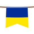 Ukraine national flags hangs on the ropes on white background. The symbol of the state in the pennant hanging on the rope.