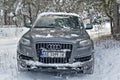 Large SUV Audi Q7 in a snowy forest.