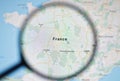 UKRAINE, ODESSA - APRIL 25, 2019: France on google maps through magnifying glass.