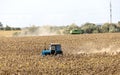UKRAINE, ODESSA - September 9, 2023: A combine harvester in a ripe sunflower field collects sunflower seeds on a sunny autumn day