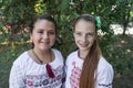 Ukraine, Pokrov - August 23, 2019: National Flag Day Celebration. Portrait of two pretty smiling girls in folk dresses with