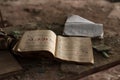 Open study book on wooden table in ruined classroom in destroyed school in Pripyt