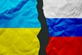 Ukraine and Russia flags painted on paper wall background, political partnership conflicts concept Royalty Free Stock Photo