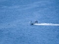 Ukraine-Russian conflict. Special forces men in camouflage uniforms on army motorboat. Boat moving across the river in the morning