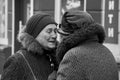 Ukraine, Shostka - February 15, 2020: Elderly women pensioners are sincerely talking on a city street