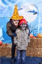 Ukraine, Shostka -November 4, 2019: Man with mystical makeup in a hat and a boy in a scary mask, celebrating halloween