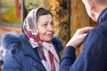 Ukraine, Shostka, Vladimirskaya Church -March 3, 2019: Elderly woman in a headscarf of the Orthodox faith in the church
