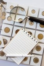 Ukraine, Sumy, October 11, 2019. Different old collector`s coins with a magnifying glass, blurred background