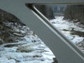 Ukraine, Yaremcha, view of the winter waterfall through the bridge support Royalty Free Stock Photo