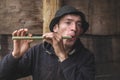 Ukraine, Yaremche. July 2019. Young guy from the mountainous terrain plays on a reed pipe, panpipe. Folk musician_