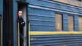 Ukraine, Yaremche - November 20, 2020: A train conductor, a woman of European appearance, in dark blue uniforms, stands at the