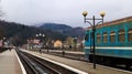 Ukraine, Yaremche - November 20, 2019: train at the station on a background of mountains. Unique railway cars on the platform in