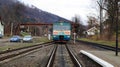 Ukraine, Yaremche - November 20, 2019: train at the station on a background of mountains. Unique railway cars on the platform in