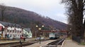 Ukraine, Yaremche - November 20, 2019: train at the station on a background of mountains. Unique railway cars on the platform in