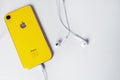 12.08.2019 Ukraine: yellow iphone xr and headphone on isolated background