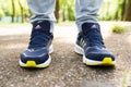 UKRAINE, ZAPOROZHYE - MAY 24, 2020 : male feet in blue Adidas shoes outdoors