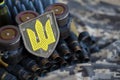 Ukrainian army symbol on machine gun belt lies on ukrainian pixeled military camouflage