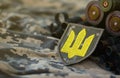 Ukrainian army symbol on machine gun belt lies on ukrainian pixeled military camouflage