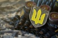 Ukrainian army symbol on machine gun belt lies on ukrainian pixeled military camouflage Royalty Free Stock Photo