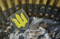 Ukrainian army symbol on machine gun belt lies on ukrainian pixeled military camouflage