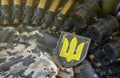 Ukrainian army symbol on machine gun belt lies on ukrainian pixeled military camouflage