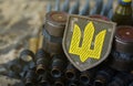 Ukrainian army symbol on machine gun belt lies on ukrainian pixeled military camouflage