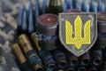 Ukrainian army symbol on machine gun belt lies on ukrainian pixeled military camouflage