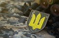 Ukrainian army symbol on machine gun belt lies on ukrainian pixeled military camouflage