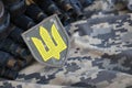 Ukrainian army symbol on machine gun belt lies on ukrainian pixeled military camouflage