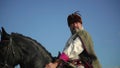 Ukrainian Ataman riding a horse in the field looks far