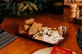 Ukrainian bacon appetizer with black bread and sauce on a plate on the table