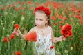 Ukrainian Beautiful girl in field of poppies and wheat. outdoor portrait in poppies