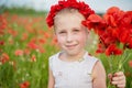 Ukrainian Beautiful girl in vyshivanka with wreath of flowers in a field of poppies and wheat. outdoor portrait in poppies. girl Royalty Free Stock Photo