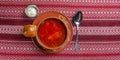 Ukrainian beetroot soup - borscht with sour cream served in a ceramic bowl over traditional red table cloth background Royalty Free Stock Photo