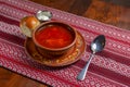 Ukrainian beetroot soup - borscht with sour cream served in a ceramic bowl over traditional red table cloth background Royalty Free Stock Photo