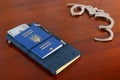 Ukrainian biometric passport and handcuffs on the table.Ukrainian biometric passport.