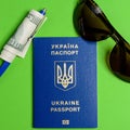 Ukrainian biometric passport with a hundred dollar bill and a pen