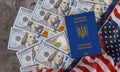 Ukrainian passport in the US flag with bills of one hundred dollars Royalty Free Stock Photo