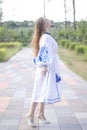 ukrainian blonde girl in national blue dress - embroidered shirt. young woman patriot. outdoors photo of charming female