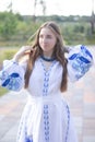 ukrainian blonde girl in national blue dress - embroidered shirt. young woman patriot. outdoors photo of charming female