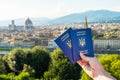 Ukrainian blue biometric passport with identification chip on against Florence background.