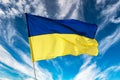 Ukrainian blue and yellow bicolor national flag on blue sky background Royalty Free Stock Photo