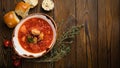 Ukrainian borsch with donuts, tomatoes and garlic