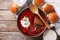 Ukrainian borsch soup and garlic buns on the table. Horizontal t