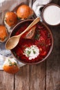 Ukrainian borsch soup and garlic buns on the table. vertical top