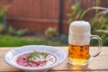 Ukrainian borsch soup served with mug of beer.