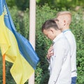 Ukrainian boys front flag with hand over heart